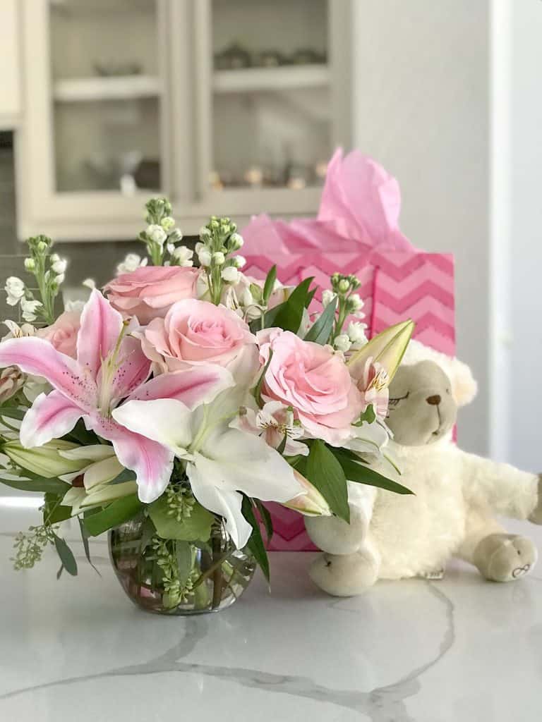 Flowers and teddy bear on table: my birth story