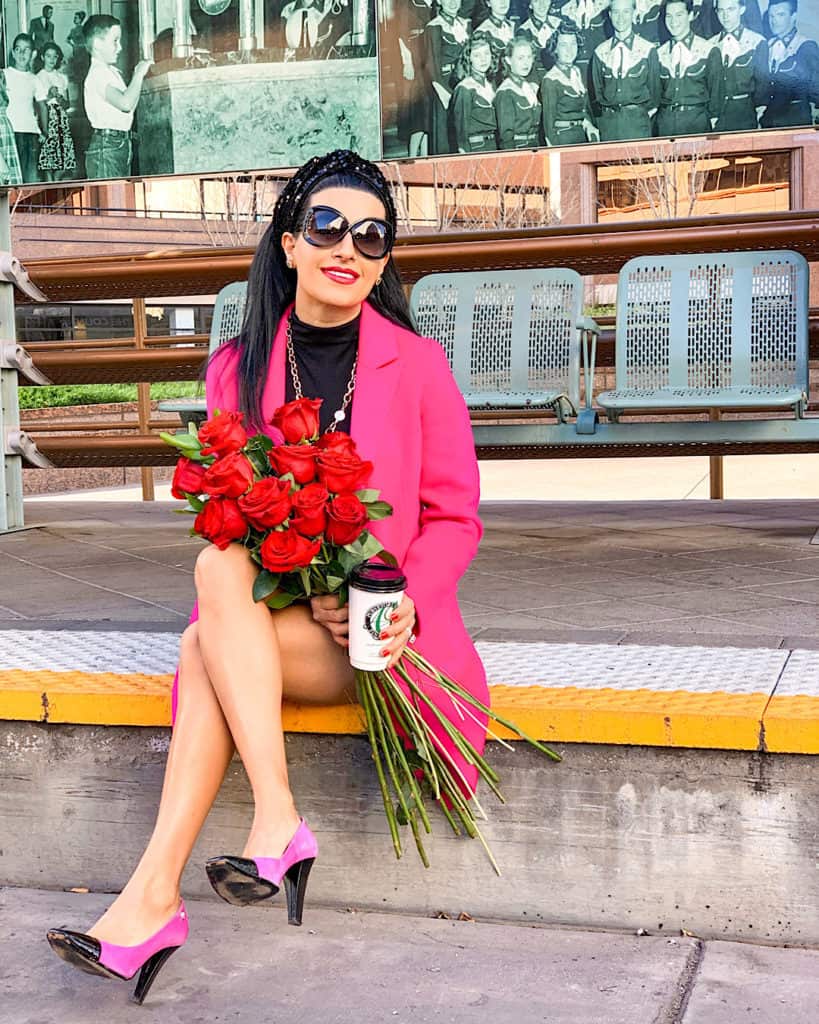 Valentine's Day outfit with pink coat pink and black heels with red roses