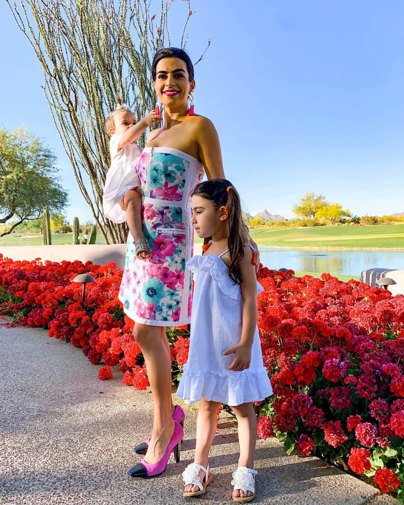 Mom and daughters on walk by flowers and lake. Ideas for Mother's Day activities and gifts