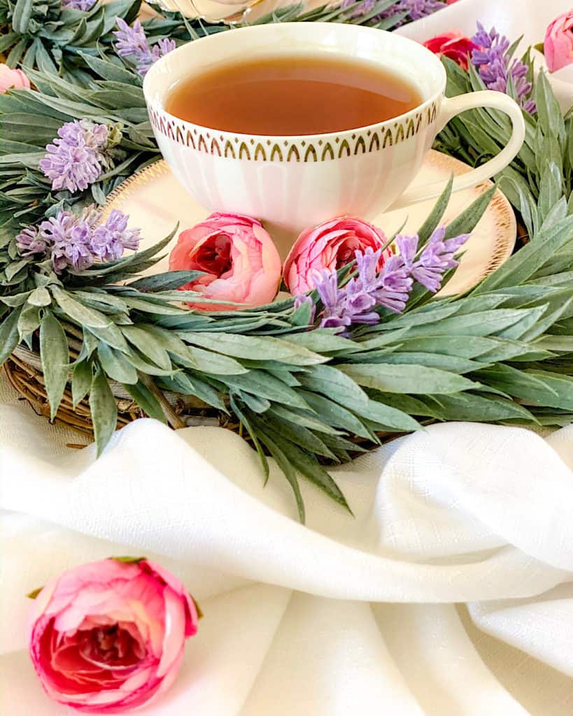 Dessert Table Design Tips: create different heights. Teacup and camelia and leaf decorations. 