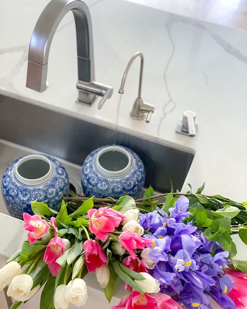 Blue and white vases and freshly cut flowers. 