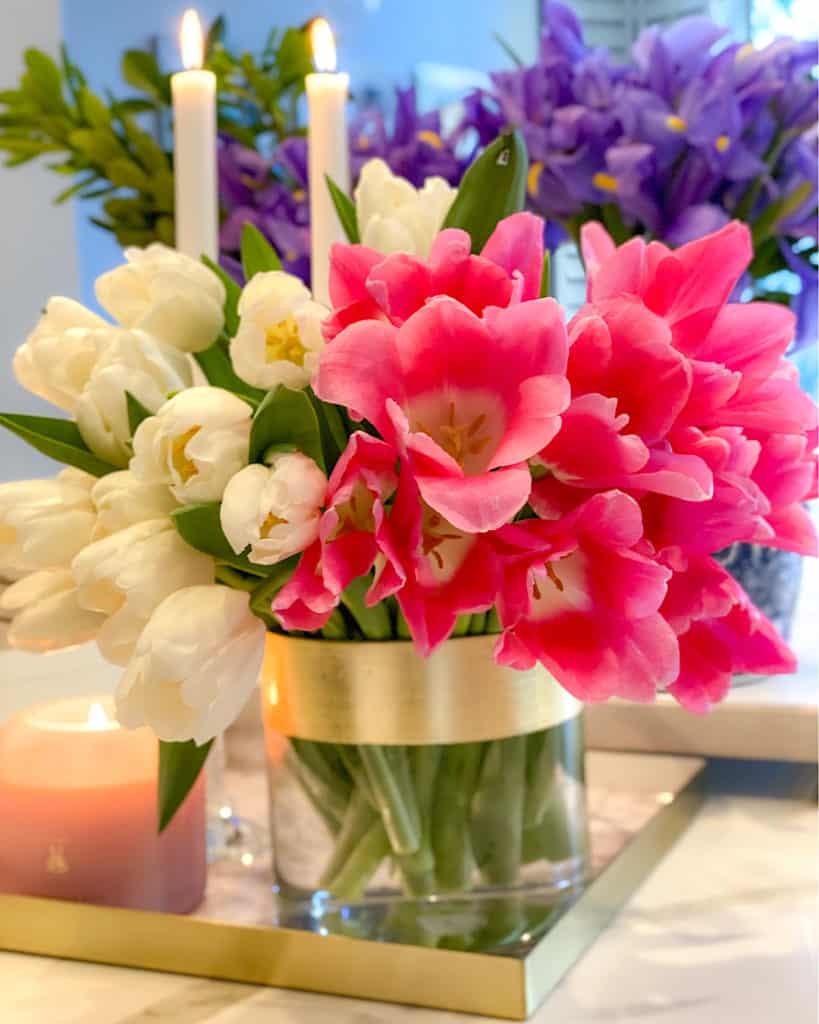 Candles and tulips in a vase. 