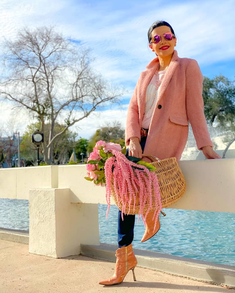 women posing in an adorable outfit for Valentine's Day in front of water 