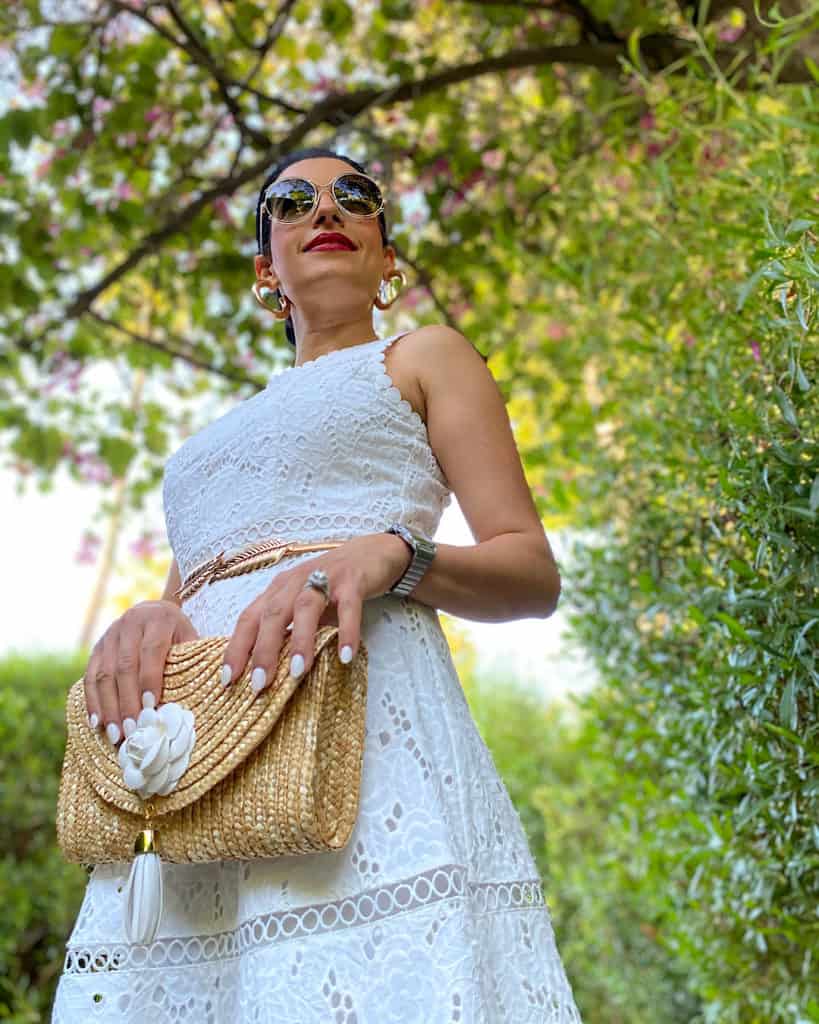 Woman wearing white dress and clutch bag