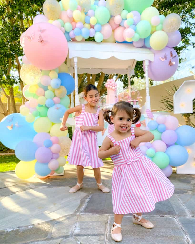 2 girls smiling and dancing