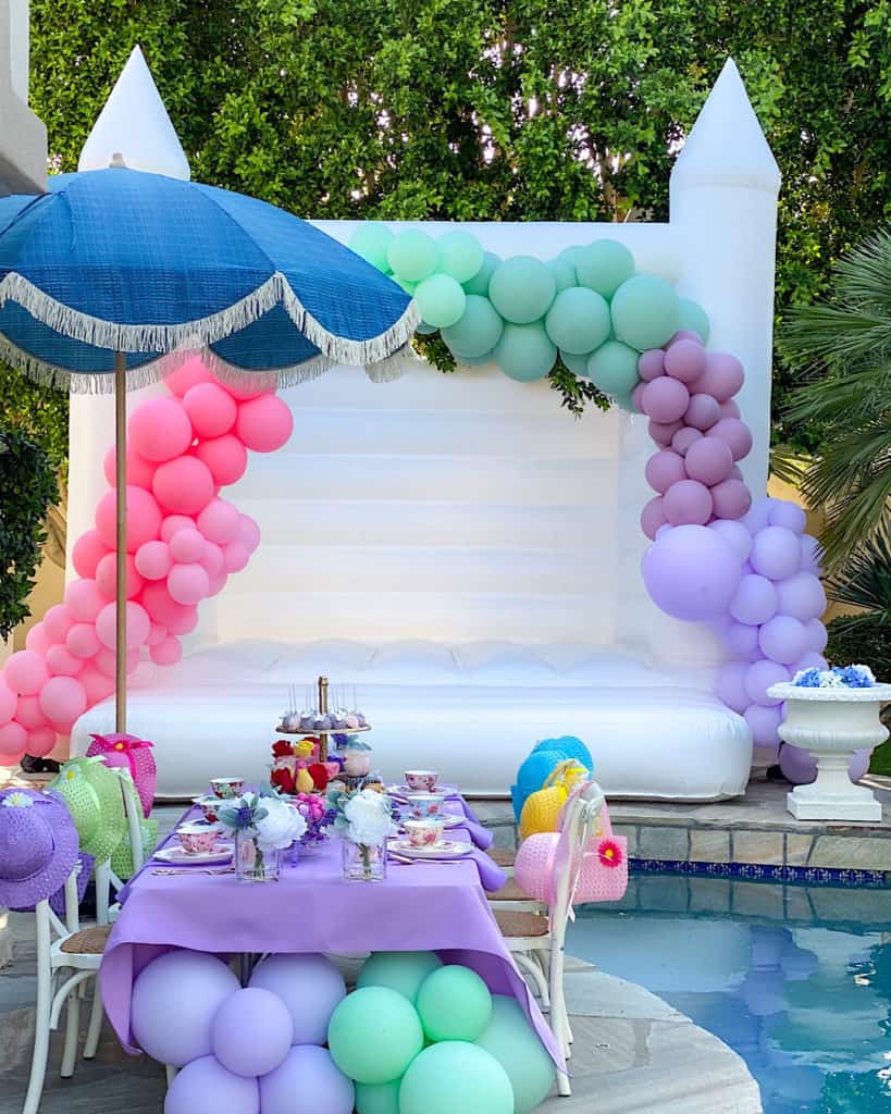 Birthday Garden Tea Party top table with white bouncy castle and balloons