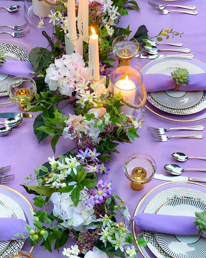 Candle and flower centrepiece on spring or summer brunch tablescape