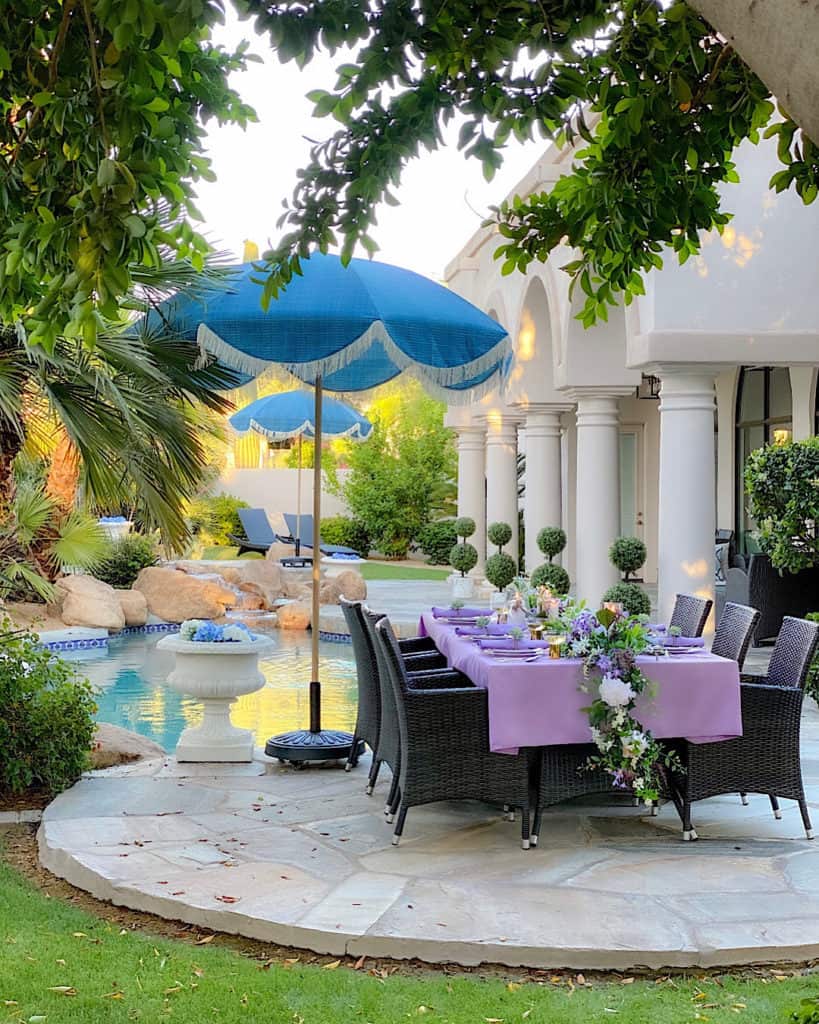 Outdoor decor trends: Purple tablescape on table by poolside