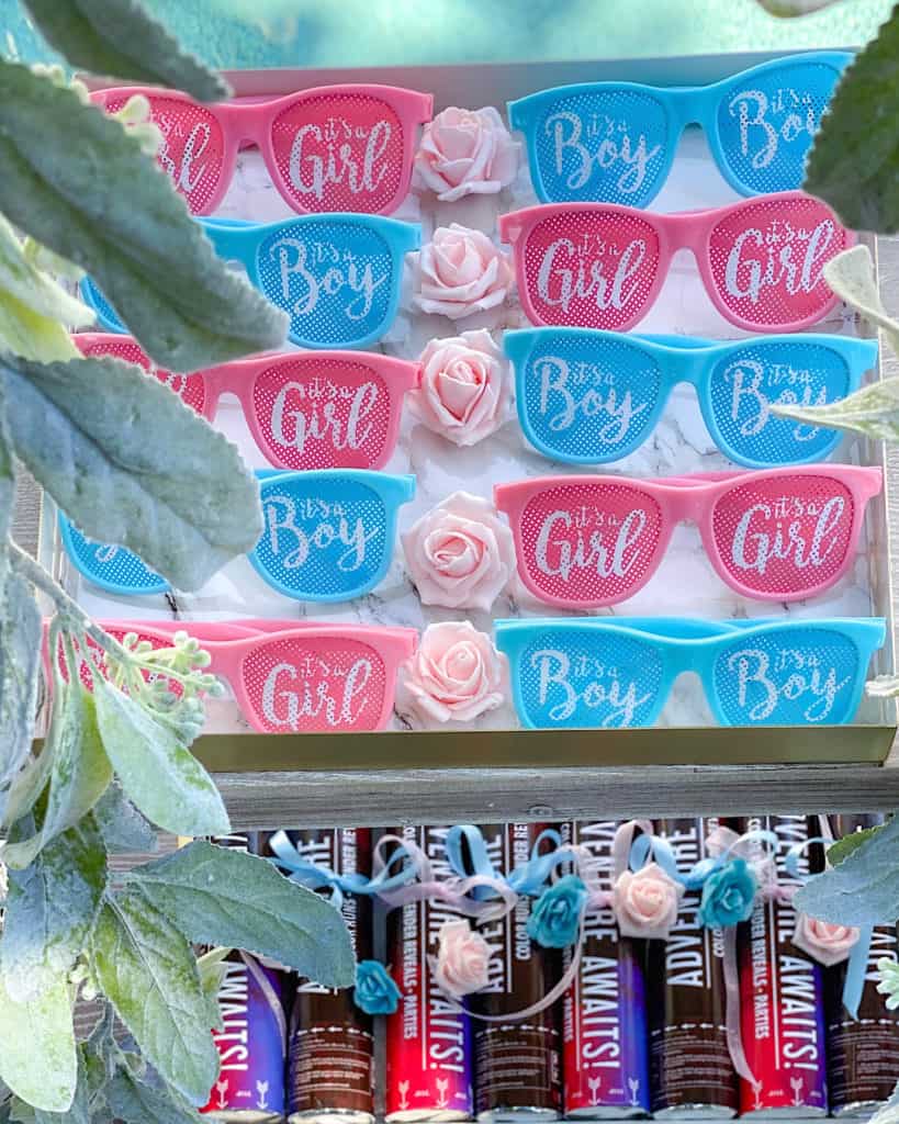 A display of It's a Boy and It's a Girl fancy dress glasses on a tray 