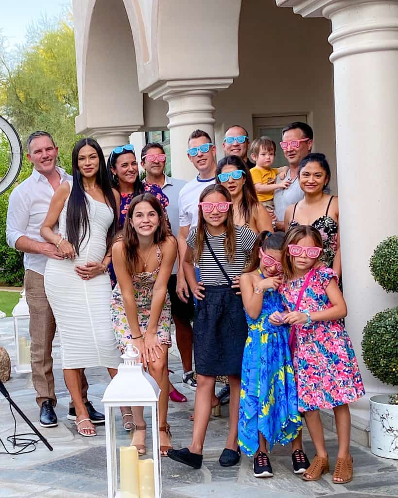 Guests wearing blue and pink fancy dress glasses at a gender reveal party