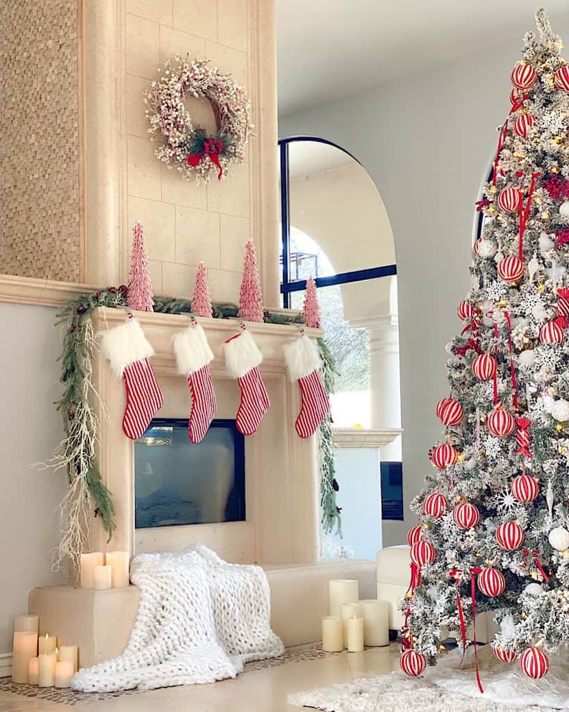 Christmas decorations on white fireplace with Stockings and candles