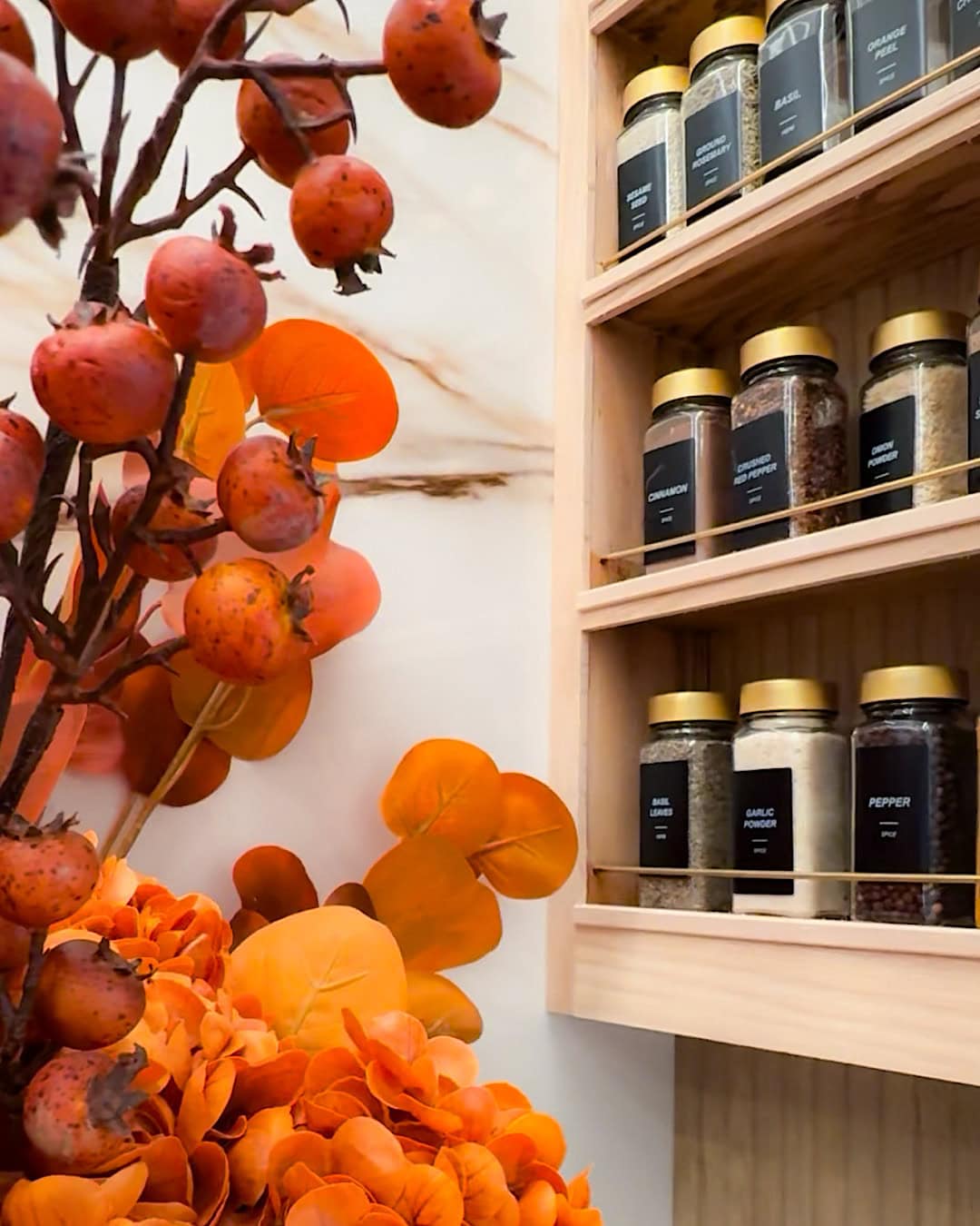 Halloween decor for the kitchen with orange berry stems and fall leaves