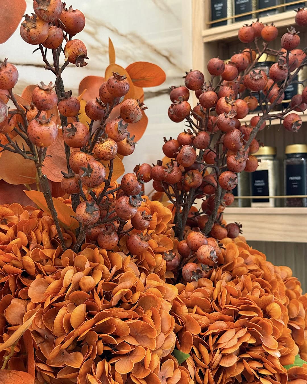 Halloween kitchen decorating ideas with orange hydrangeas and berry stems