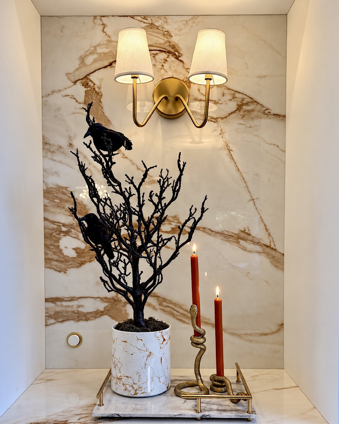 Halloween kitchen ideas with black branches, crows and taper candles on a tray