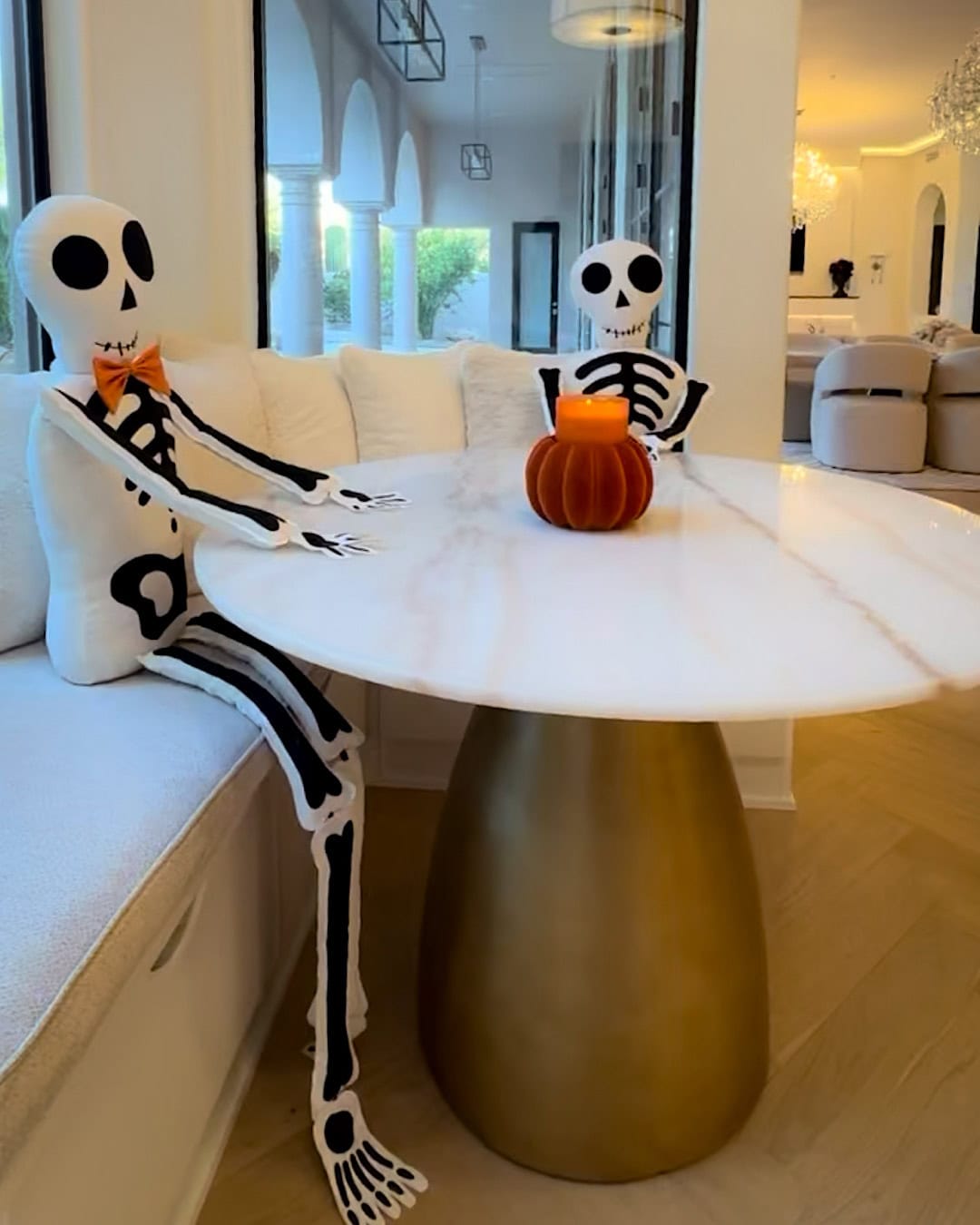  Halloween kitchen table decor with two skeletons sitting at the breakfast table