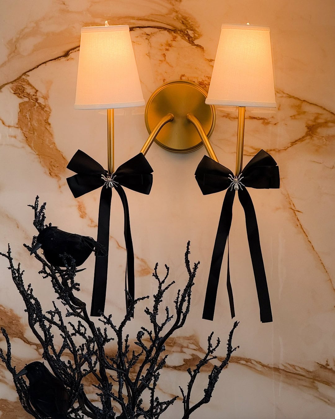 Halloween themed kitchen with black silk bows on brass sconces